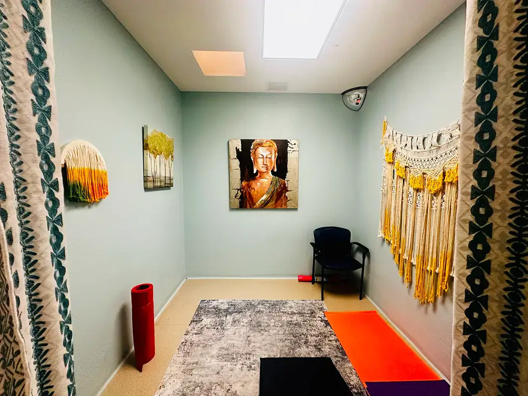 Private therapy room at Texas Helps rehab center with rug, chair, yoga mat