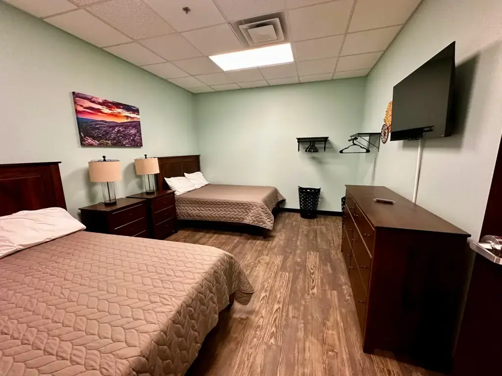 Shared residential bedroom at Texas Helps rehab center with two beds